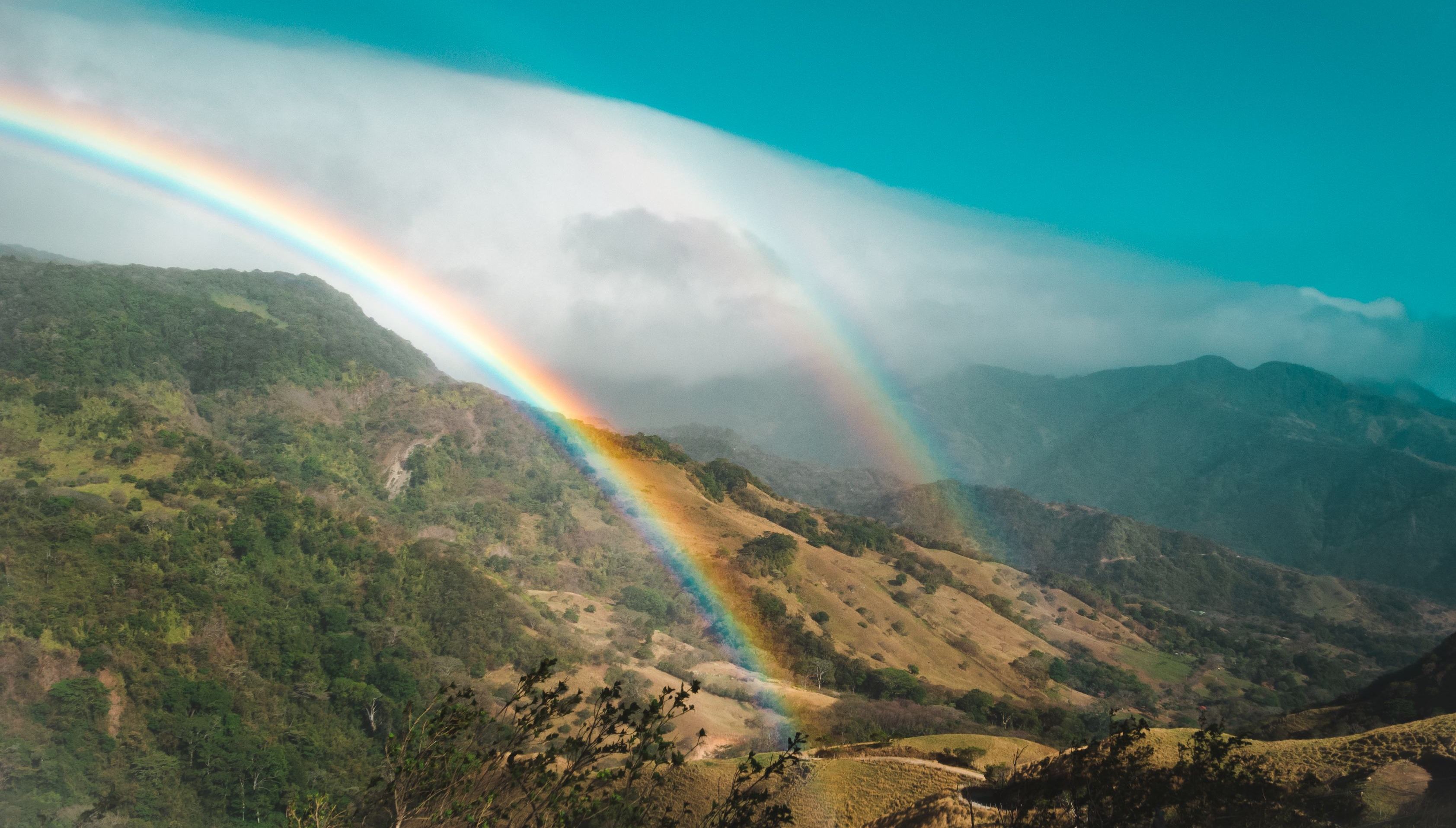 A double rainbow shining over the mountainous landscapes of Monteverde, Costa Rica.