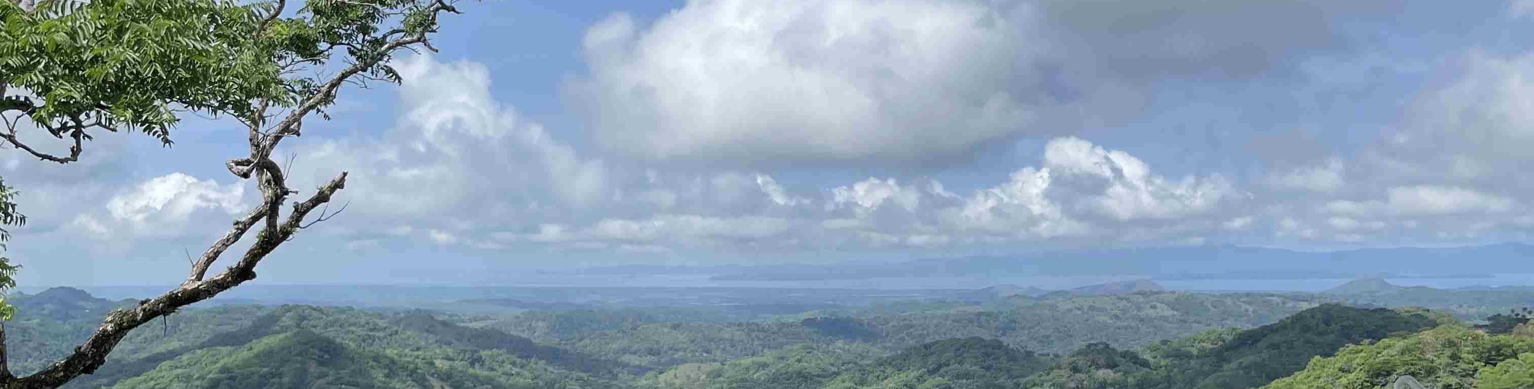 Three refreshing drinks on a balcony overlooking Monteverde’s stunning landscapes in Costa Rica.