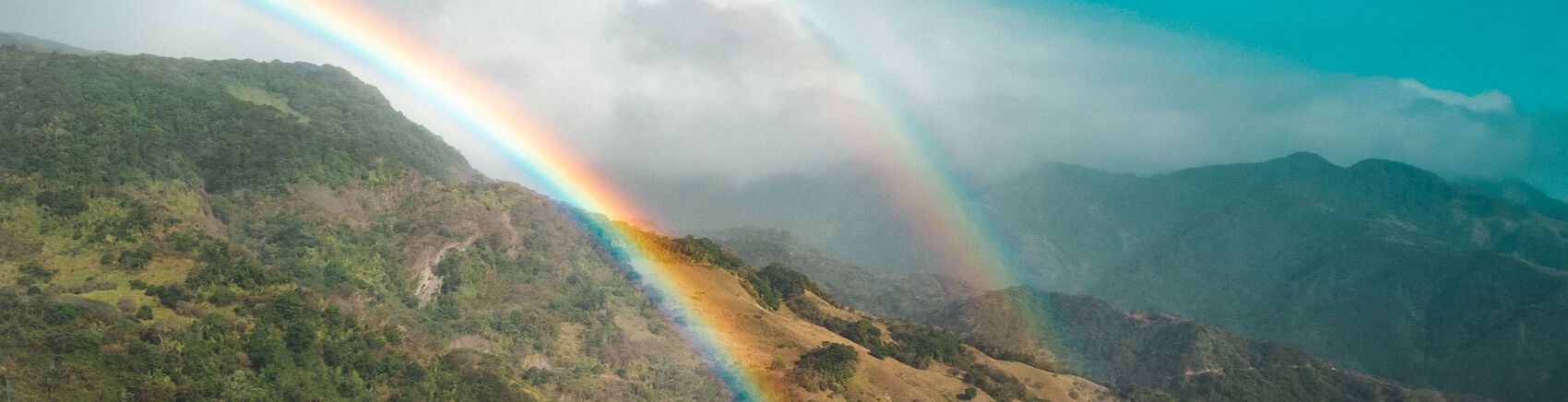 Double rainbow shining over the mountainous landscapes of Monteverde, Costa Rica.